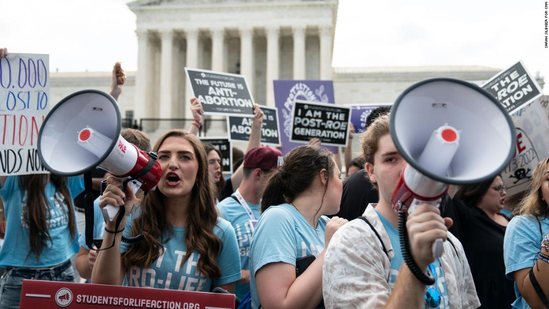 Noah Slayter, right, demonstrates with fellow anti-abortion activists in front of the Supreme Court on Friday. &quot;I was here right when the decision was delivered,&quot; said Slayter. &quot;I am ecstatic. I was walking on air earlier.&quot;