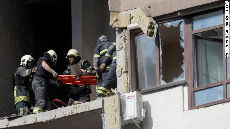 Los equipos de rescate evacuan a una persona de un edificio residencial dañado por un ataque con misiles rusos en Kyiv, Ucrania, el 26 de junio de 2022. 