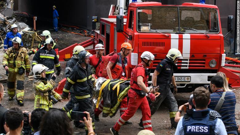 Rescuers evacuate a person from an apartment building destroyed in a Russian airstrikes in the Shevchenkivskiy district of Kyiv on June 26, 2022.