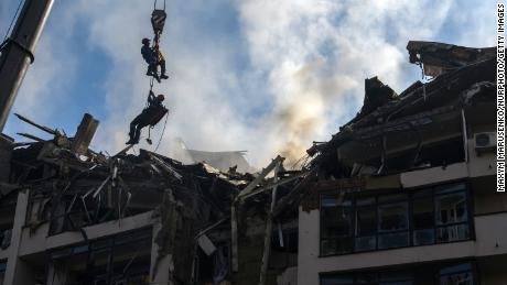 Rescuers elevated by a crane at an apartment building destroyed in a Russian airstrikes in the Shevchenkivskiy district of Kyiv, Ukraine. June 26, 2022. 