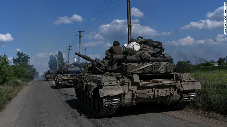 A column of Ukrainian army tanks rolls down a road near Lysychansk on June 19, 2022.