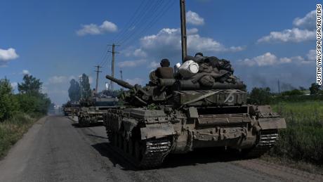 A column of Ukrainian army tanks rolls down a road near Lysychansk on June 19, 2022.
