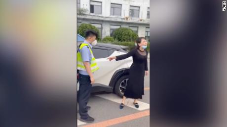 A Dandong resident is stopped by police for not having the proper documentation as she attempts to pick up medicine at a hospital.