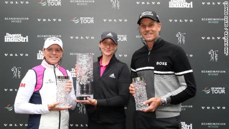 Grant is presented with the Scandanavian Mixed trophy by tournament hosts Annika Sorenstam and Henrik Stenson.