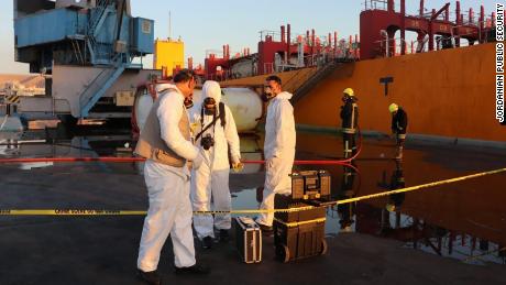 Workers in hazmat suits respond to the toxic gas leak at Jordan&#39;s port of Aqaba on Monday.