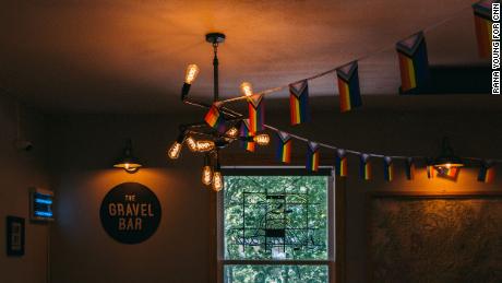 Flags hang from the Gravel Bar&#39;s ceiling at Wanderoo Lodge on June 21.