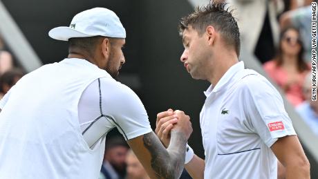 Kyrgios (left) and Krajinovic (right) shake hands after their second round match at Wimbledon.