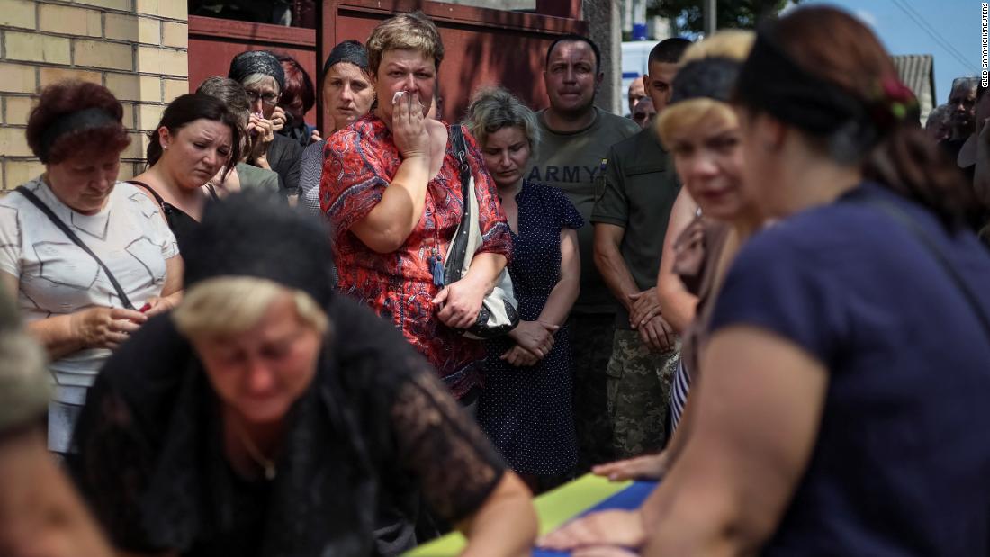 People attend a funeral ceremony for Ukrainian serviceman Volodymyr Kochetov, 46, in the village of Babyntsi, Ukraine, on June 30.