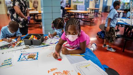 Students write positive affirmations on poster board at P.S. 5 Port Morris, an elementary school in the Bronx borough of New York City, on August 17, 2021. The school system is one of the nation&#39;s largest and most segregated.