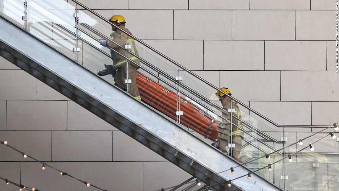 Members of the emergency services take stretchers to the scene of the shooting at the Field&#39;s shopping center in Copenhagen, Denmark, on July 3.
