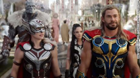 Natalie Portman (left) as Thor walks out with Chris Hemsworth's original Thor in a moment of Thor-ception.