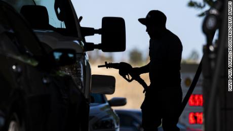 A customer holds a fuel nozzle at a Shell gas station in Hercules, California, U.S., on Wednesday, June 22, 2022. 