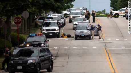 Officers work the scene after a mass shooting at a Fourth of July parade in Highland Park, Illinois.