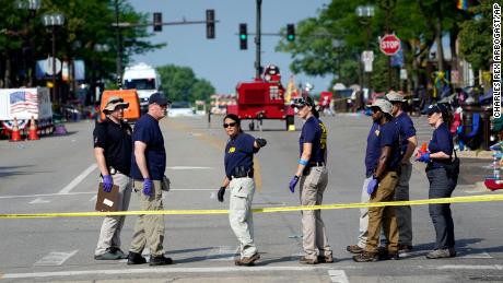 Members of the FBI&#39;s evidence response team organize one day after a mass shooting in downtown Highland Park, Illinois, on Tuesday, July 5, 2022. 