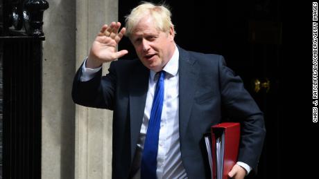 Boris Johnson is clinging to his prime ministership after dozens of British lawmakers resigned and urged him to step down.
