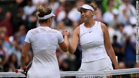 Anisimova (right) and Halep meet at the net in their quarter-final match at Wimbledon. 