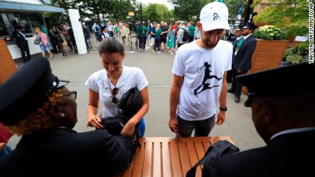 Spectators go through security checks at the entrance gate at Wimbledon.