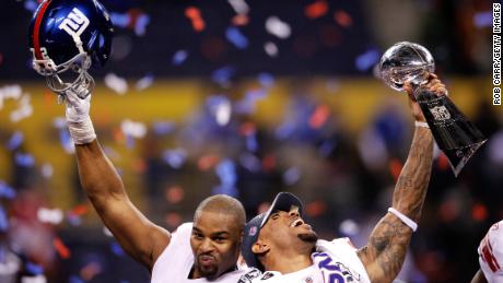 Umenyiora (left) celebrating the Giants' Super Bowl XLVI win in February 2012 with teammate Devin Thomas.