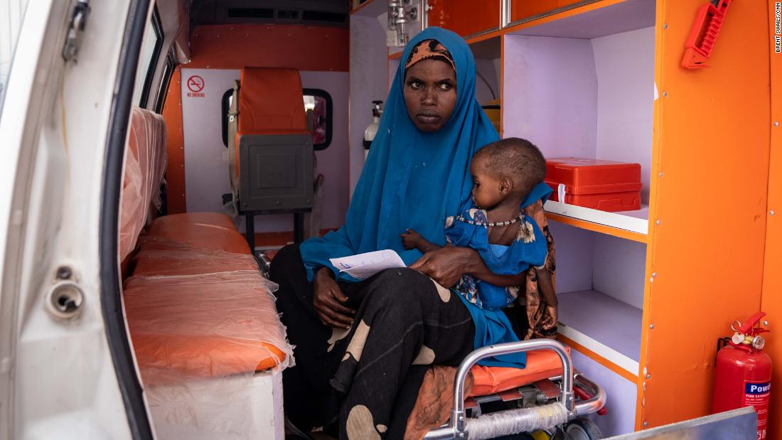 Ijabu Hassan sits in an ambulance waiting for help she could not get at home.