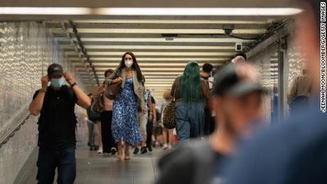 Some passengers wear masks at the Times Square subway station in New York last week. 