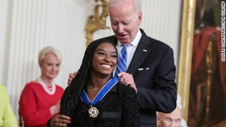 American gymnast Simone Biles receives the Presidential medal of Freedom from President Joe Biden in the East Room of the White House on July 7, 2022 in Washington, DC. 