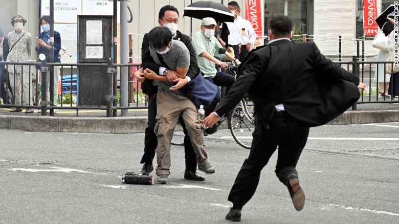 Security personnel detain Tetsuya Yamagami near the site where Shinzo Abe was shot in Nara, Japan, on July 8.