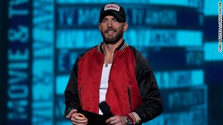 Chris Evans wears a hat with the NASA"worm"  Logo at the MTV Movie and TV Awards on Sunday, June 5, 2022 at the Barker Hangar in Santa Monica, California. 