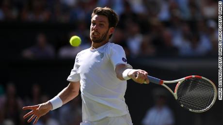 Norrie takes a right hand against Djokovic on center court. 