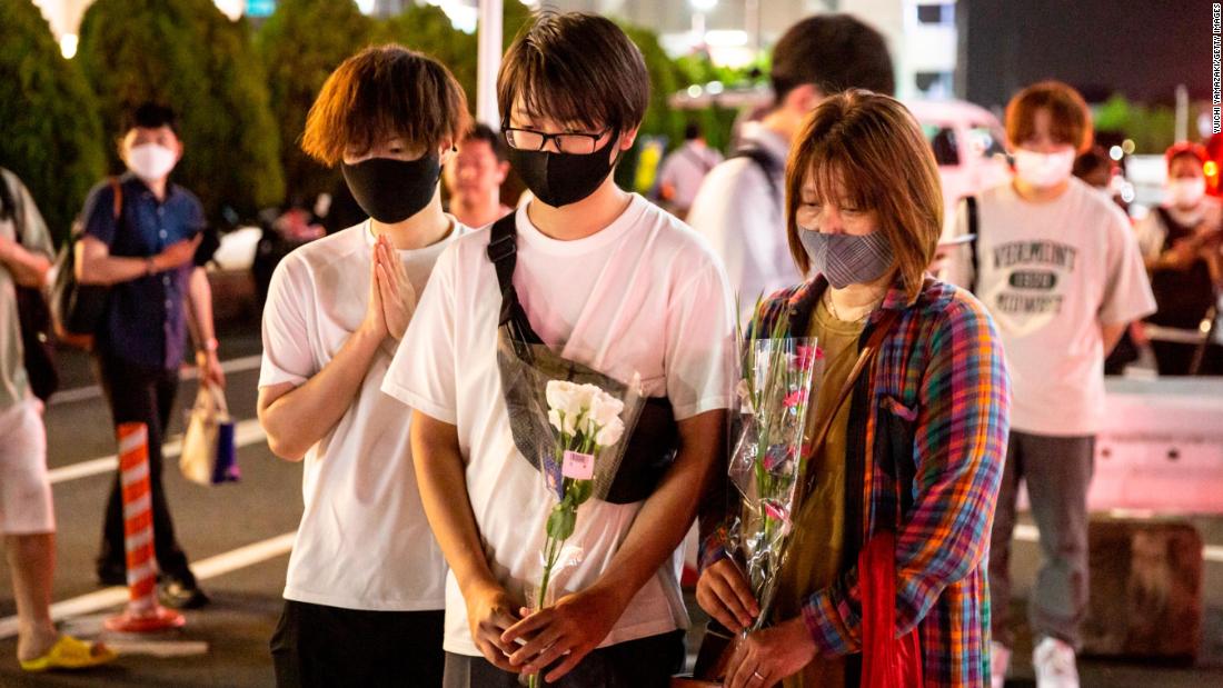 People pray in Nara on Friday.