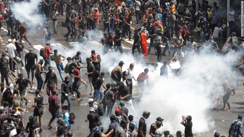 Demonstrators run from tear gas used by police during a protest demanding the resignation of President Gotabaya Rajapaksa near the president&#39;s residence in Colombo, Sri Lanka, on Saturday.