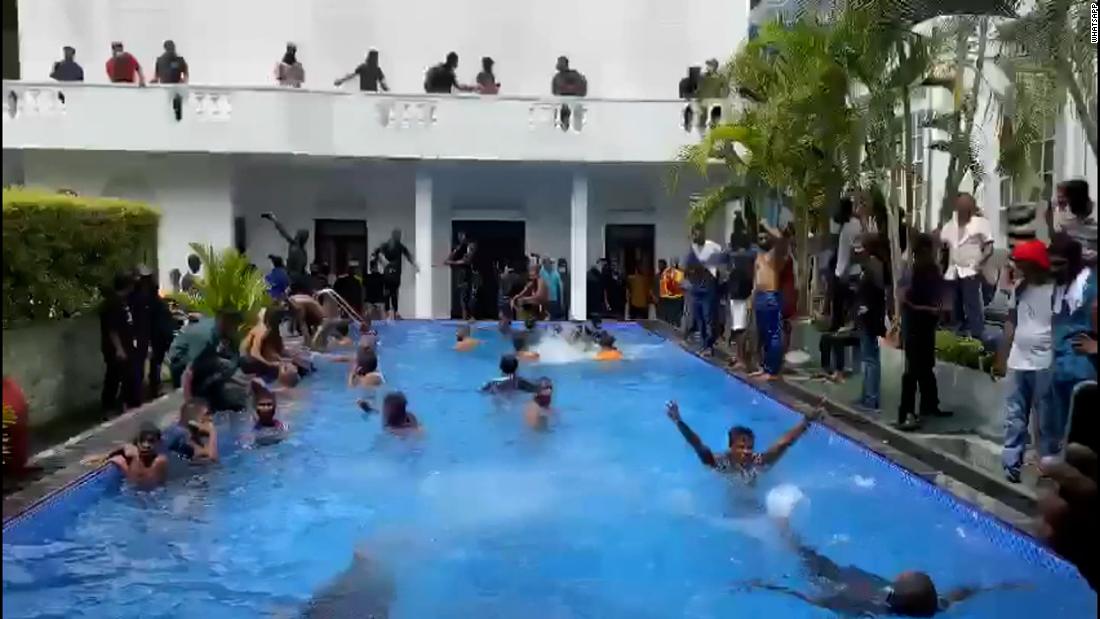 Protesters take a swim in presidential pool after storming palace