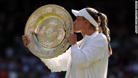 Rybakina kisses the trophy as she wins the Wimbledon Women's Singles title.