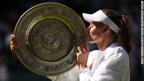 LONDON, ENGLAND - JULY 09: Elena Rybakina of Kazakhstan kisses the trophy after victory against Ons Jabeur of Tunisia during the Ladies&#39; Singles Final match on day thirteen of The Championships Wimbledon 2022 at All England Lawn Tennis and Croquet Club on July 09, 2022 in London, England. (Photo by Clive Brunskill/Getty Images)
