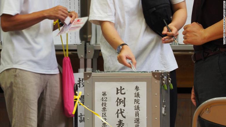 A voter casts a ballot during Japan&#39;s upper house elections at a polling station in Tokyo on July 10, 2022.