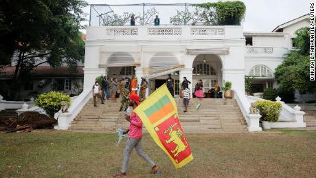 A demonstrator walks in the garden at the Prime Minister&#39;s residence on the following day after demonstrators entered the building, amid the country&#39;s economic crisis, in Colombo, Sri Lanka July 10, 2022. REUTERS/Dinuka Liyanawatte