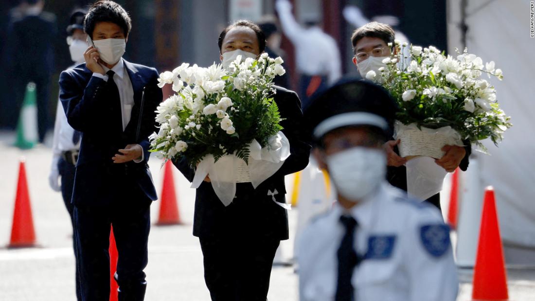 Officials carry flowers at the Zojoji Temple, where the vigil and funeral of late former Japanese Prime Minister Shinzo Abe will be held, in Tokyo, Japan, on July 11.