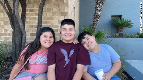 AJ Martinez, right, with his brother and sister.