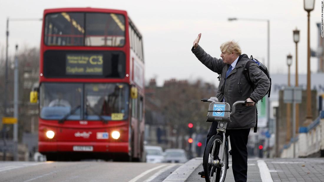 Johnson waves on London&#39;s Wandsworth Bridge as a bike-sharing program was expanded in the city in 2013.