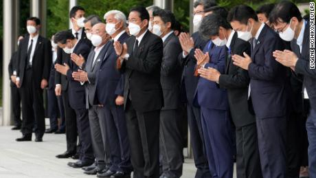 Japan&#39;s Prime Minister Fumio Kishida, officials and employees offer prayers outside the Prime Minister&#39;s Office in Tokyo on July 12.