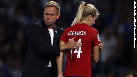 Norway&#39;s head coach Martin Sjögren consoles Ada Hegerberg as she leaves the pitch.