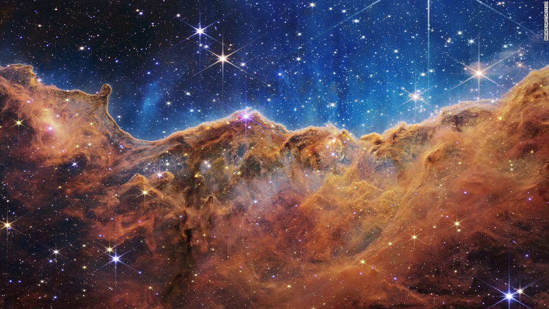 Webb&#39;s landscape-like view, called &quot;Cosmic Cliffs,&quot; is actually the edge of a nearby, young, star-forming region called NGC 3324 in the Carina Nebula. The telescope&#39;s infrared view reveals previously invisible areas of star birth. 