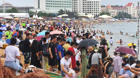 People swarm to the beach in the summer heat in Qingdao, China, on July 10.