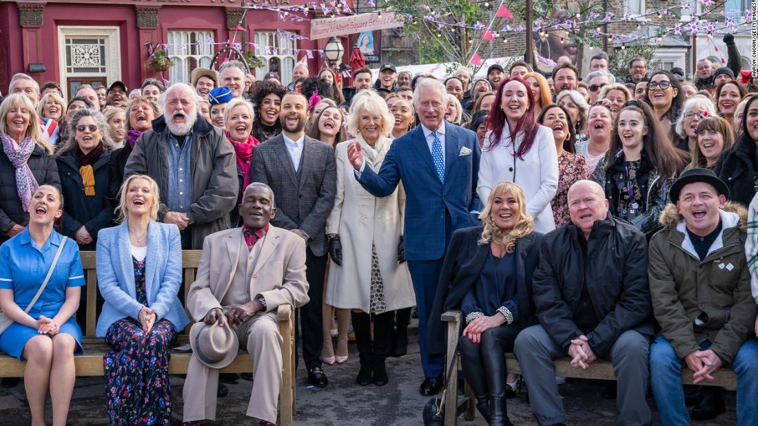 Charles and Camilla pose for a group photo as they visit the set of &quot;EastEnders&quot; in March 2022.