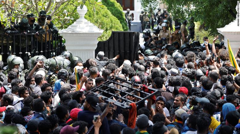 Demonstrators carry the gate to Sri Lanka's Prime Minister Ranil Wickremesinghe's office premises, during protests in Colombo on Wednesday.