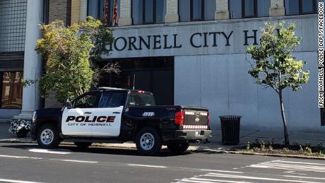 Three people are arrested after distributing leaflets with hate symbols at places of worship in Hornell, New York, police say.