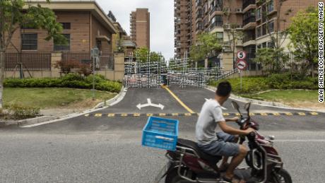 Barricades from recent Covid-related closures block an entrance leading to the Fengming Haishang residential development of Country Garden Holdings Co. in Shanghai, China, Tuesday, July 12, 2022. 