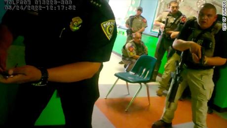 In this still from a video released by Uvalde Mayor Don McLaughlin, officers attempt to open the door of a classroom inside Robb Elementary.