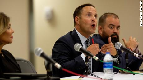 Rep. Dustin Burrows, center, speaks with committee members during a press conference after the viewing of the video from inside Robb Elementary School on July 17, 2022. 