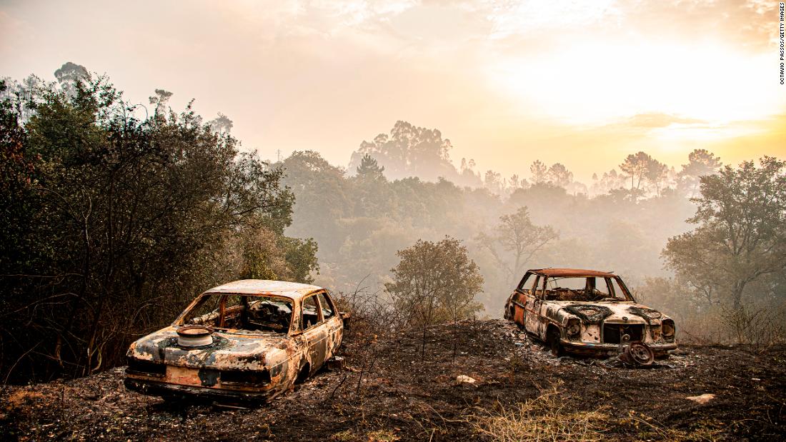Burnt-out cars are seen in central Portugal on July 14.