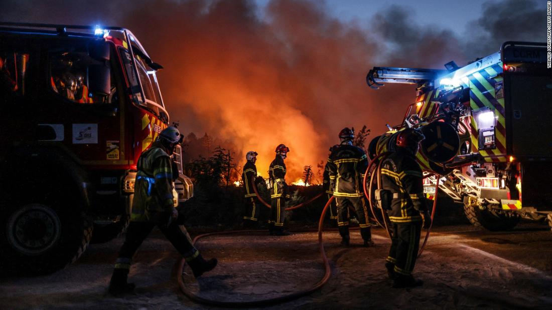 Firefighters try to control a wildfire in Louchats, France, on July 17.